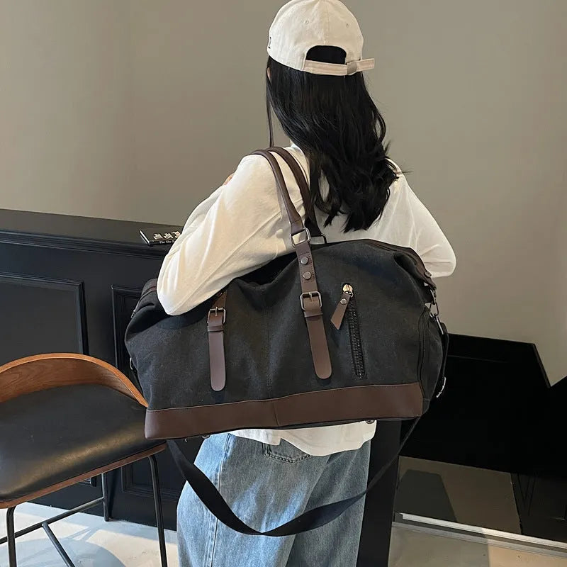 Canvas travel shoulder bag for men and women in solid black colour, breathable fabric, compact unisex design