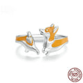 Silver ring with a raised cartoon corgi dog design and electroplated colour finish.