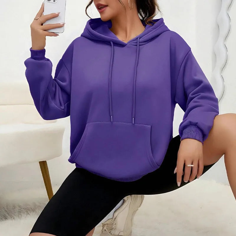 Women's loose black drawstring pocket sweatshirt with long sleeves and a front kangaroo pouch.