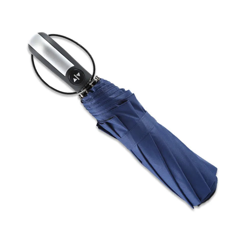 Automatic triple folding business umbrella in black colour showing steel ribs and rubber handle