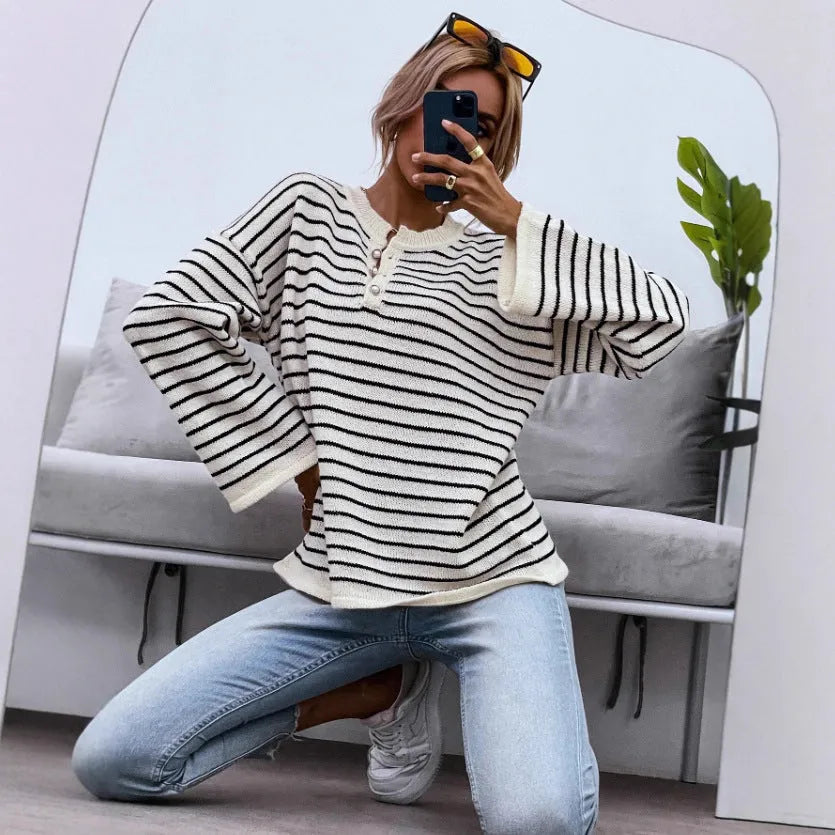 Black striped women's casual top with drop-shoulder sleeves and button detailing