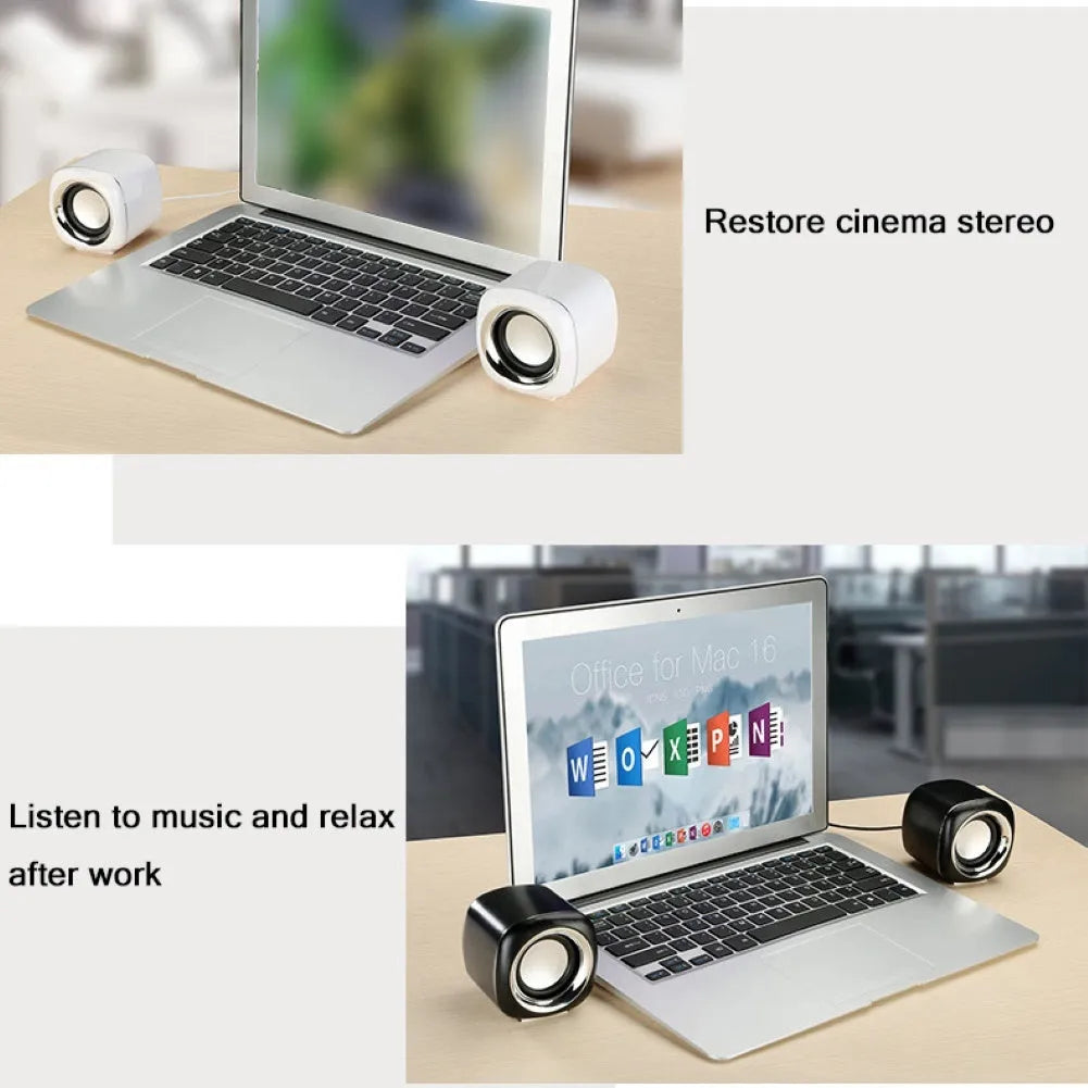 Pair of black wired mini desktop computer speakers with 3.5mm plug and scroll wheel volume control on a desk
