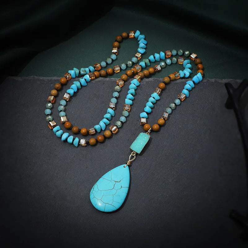 Long blue turquoise imitation mineral pendant necklace with a geometric setting on a ball bead chain.