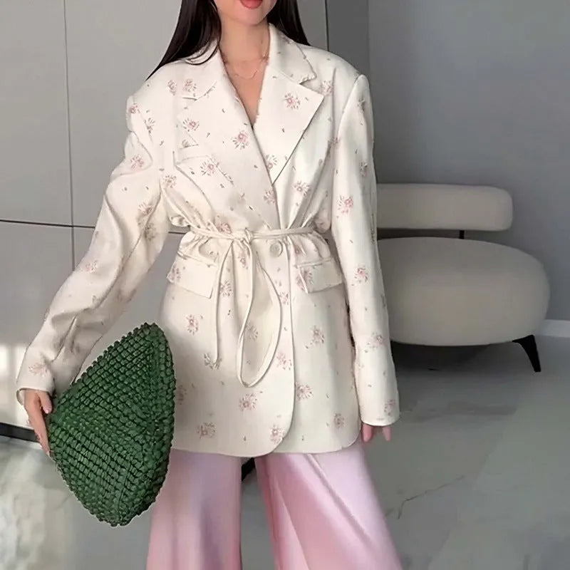 Women's apricot suit jacket with lace-up detail on the collar and a cinched waist.