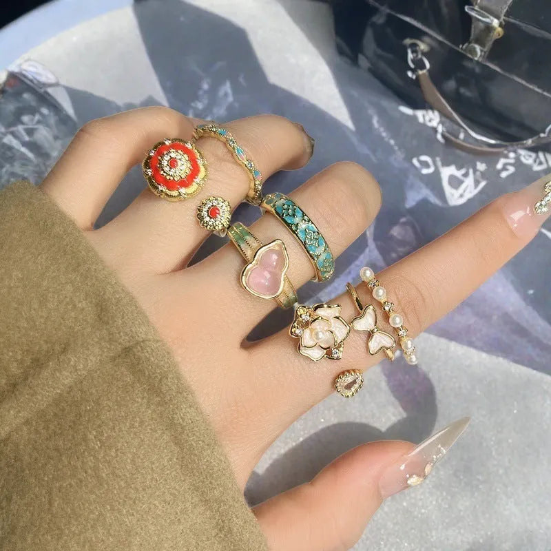 Copper adjustable ring with gourd motif, flower and bow shape, inlaid zircon, and vintage oil drip finish.