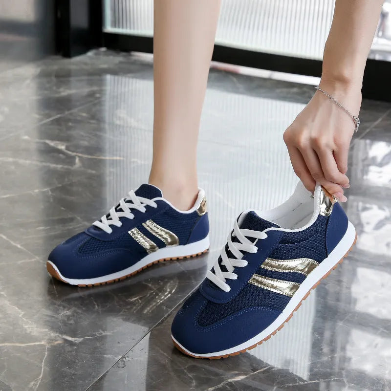 Blue women's casual tennis shoes with cross straps and white rubber sole