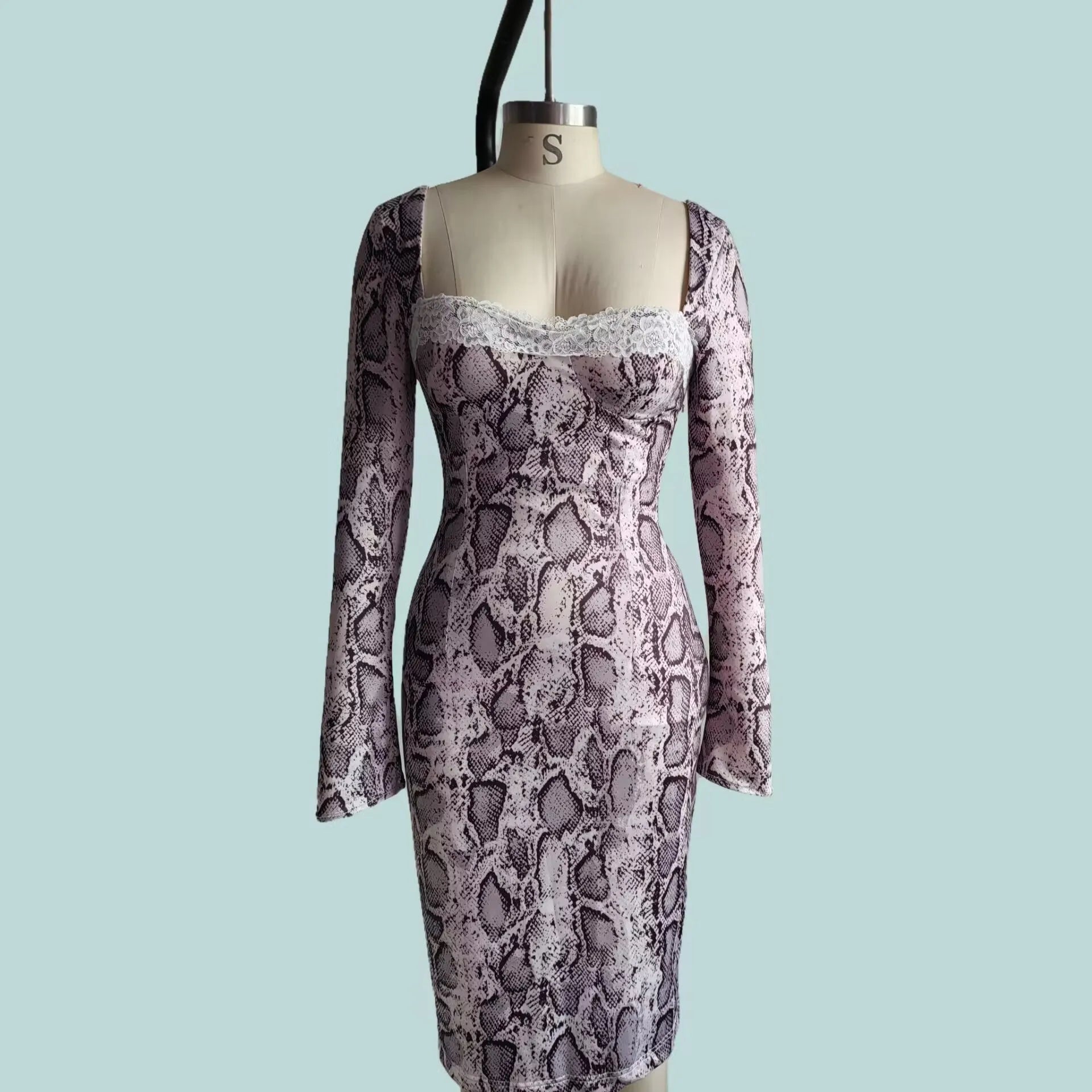 Grey slim fit lace dress with digital printed 3D pattern and long sleeves on a mannequin.