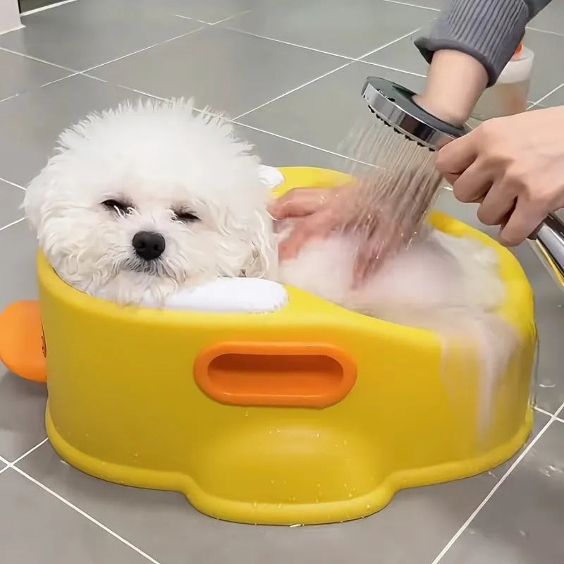 A blue duck-shaped PVC bath tub for washing dogs and cats on a bathroom floor.