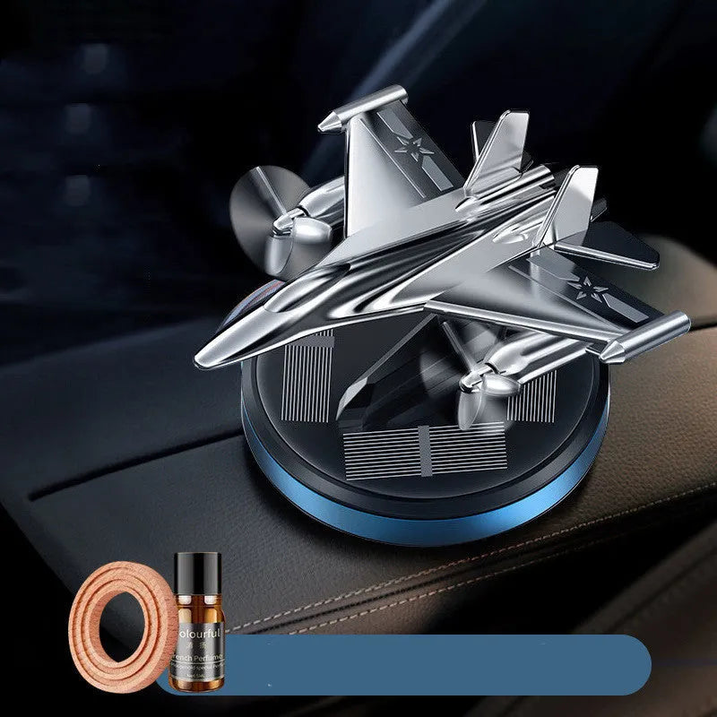 Silver solar powered rotating fighter jet perfume ornament on a beech wood base.