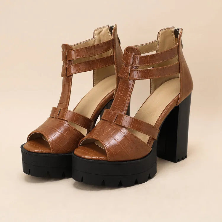 Black platform high heel sandals with round head and back zipper on plain background