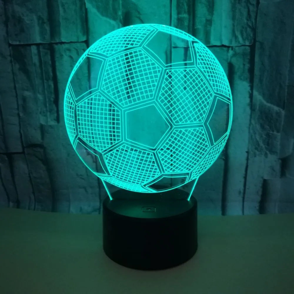 3D acrylic football night light on a square black base, showing multi-coloured LED illumination.