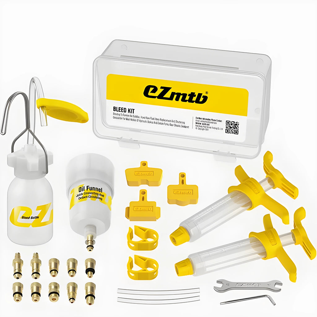 EZmtb bicycle hydraulic disc brake oil bleed kit tools with syringes, adapters, and wrenches on a workbench