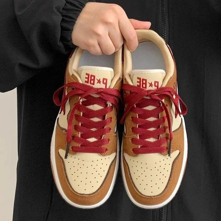 Brown low-top platform sneakers with sequins, lace-up fastening, and rubber sole on light background