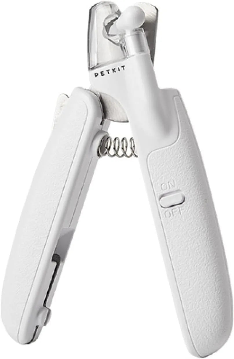 White pet nail clippers with LED light, transparent guard, and a separate nail file on a plain background.