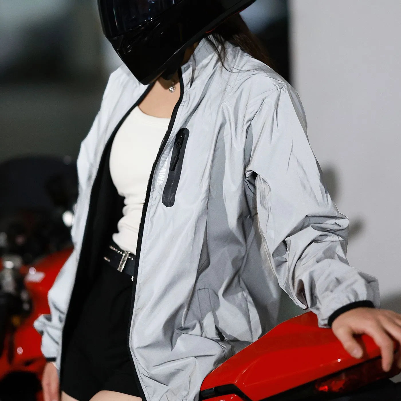 Silver waterproof polyester windproof coat with long sleeves showing Asian and European sizing labels
