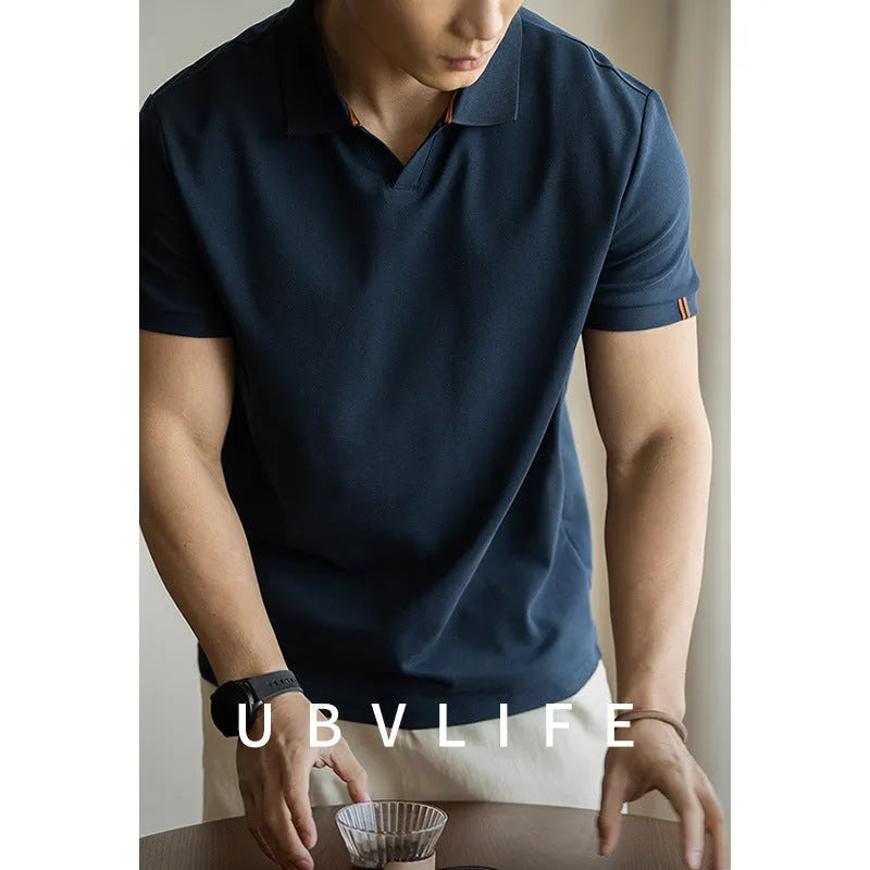 Men's short-sleeved blue polo shirt with a placket and collar, laid flat.