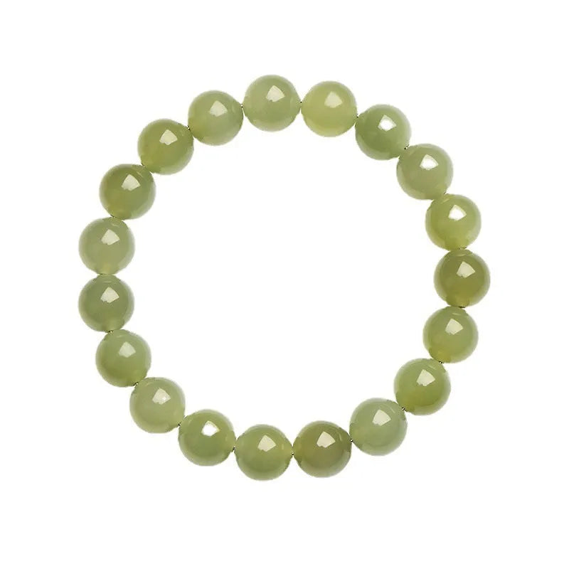 Polished Hetian jade ball bracelet with ice-like translucent beads in spherical shapes on a plain background