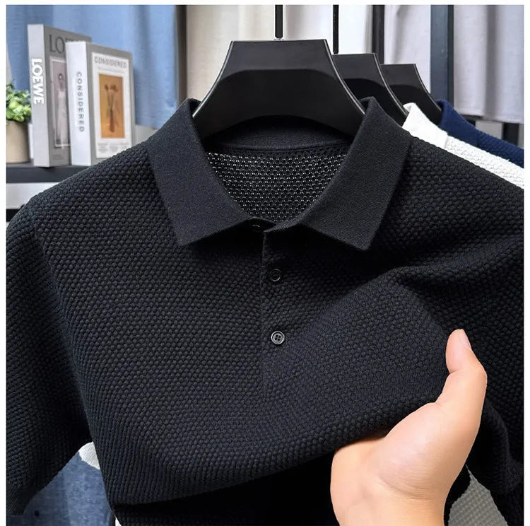 Man wearing a loose grey short sleeve cotton sweater, casual pullover style
