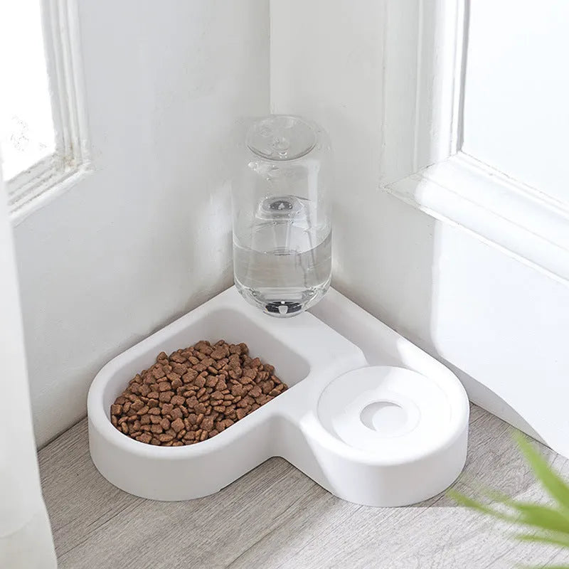 White pet water fountain for cats and dogs indoors on a kitchen floor.