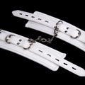 White PU sponge bondage set showing handcuffs, footcuffs and neck scarf for comfortable restraint accessories