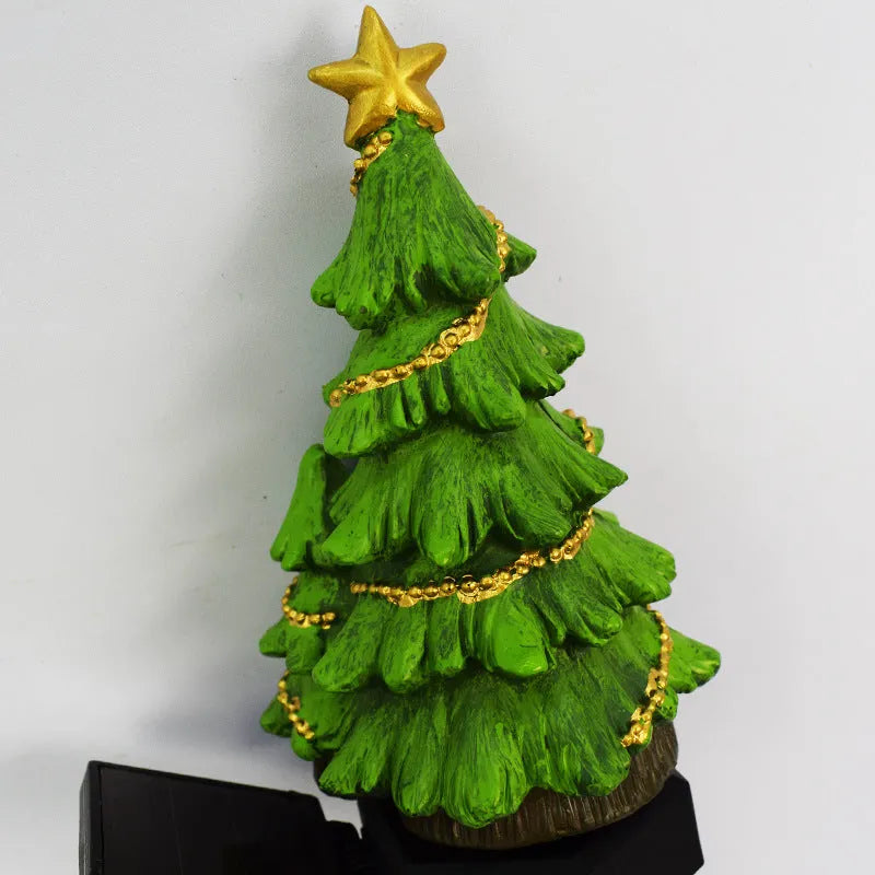 Solar Christmas tree ground plug light with resin body, warm white LED, and 40x40mm solar panel on a lawn