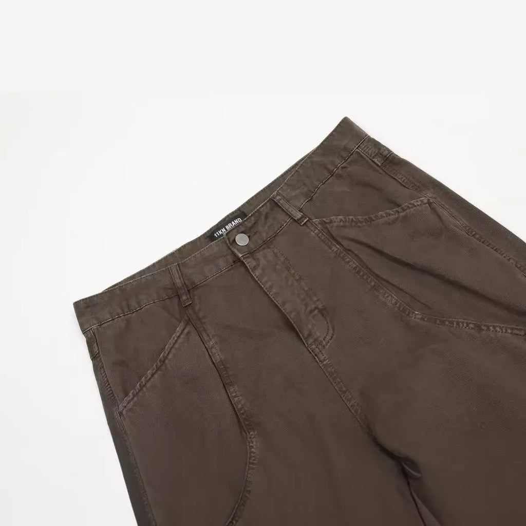 Men's loose straight-leg cotton trousers in brown colour with a high waist and wide leg opening.