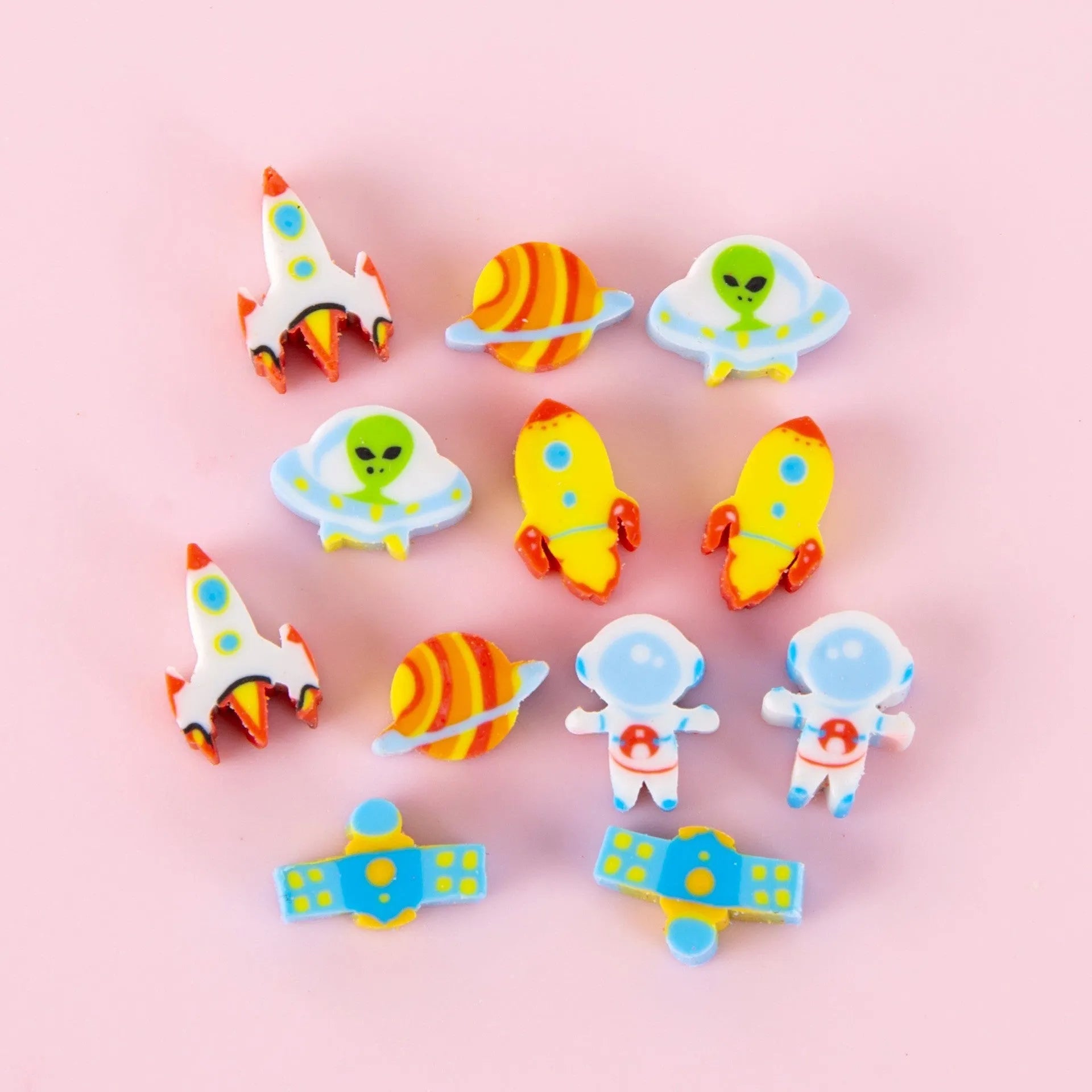 50 small colourful cartoon novelty erasers including fruit and animal shapes in a pearlescent film bag.