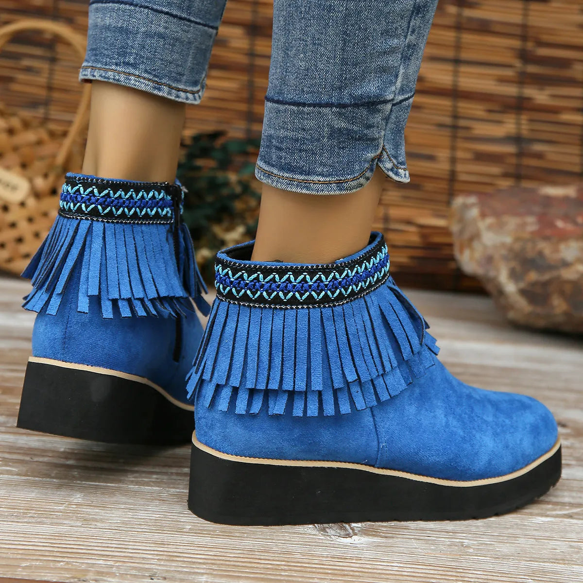 Women's suede wedge ankle boots in dark brown with a side zipper and tassel detail.