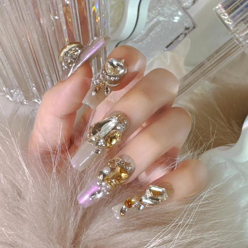 False nail patches with rhinestone embellishments in S number sizing on card paper packaging