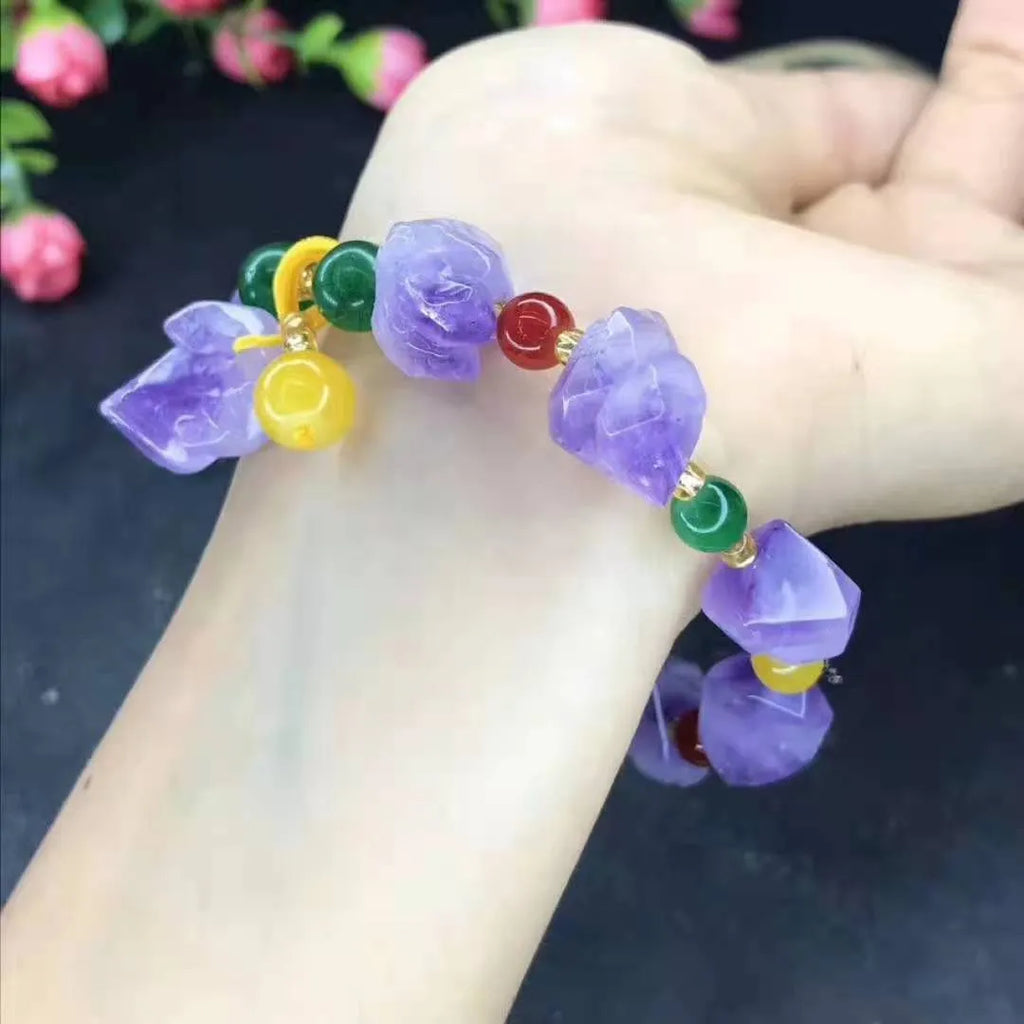 Natural shaped purple amethyst bead bracelet with a silver fu charm on an adjustable knotted cord.