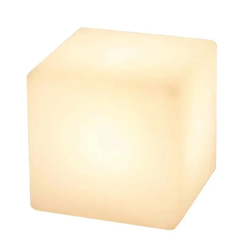 Modern LED illuminated cube stool in outdoor garden setting showing waterproof construction and integrated lighting
