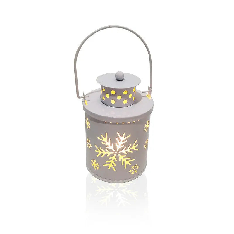 Wrought iron LED candle lantern with flickering light, available in green, white, and red, on a wooden shelf