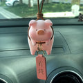 A cartoon pig figurine car dashboard ornament made of resin.