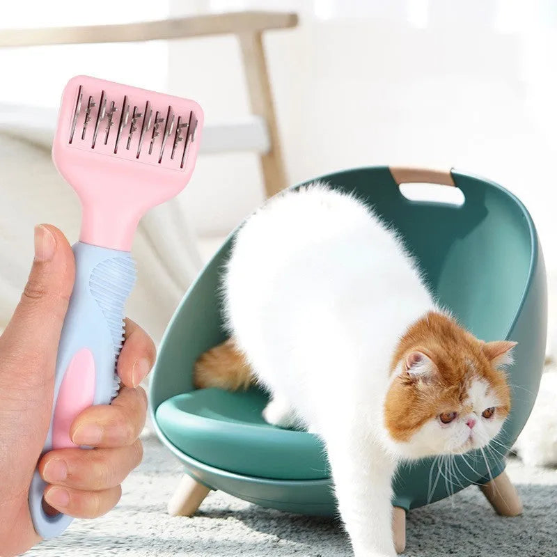 Pink stainless steel dog comb with built-in knot knife and massage teeth for pet grooming.