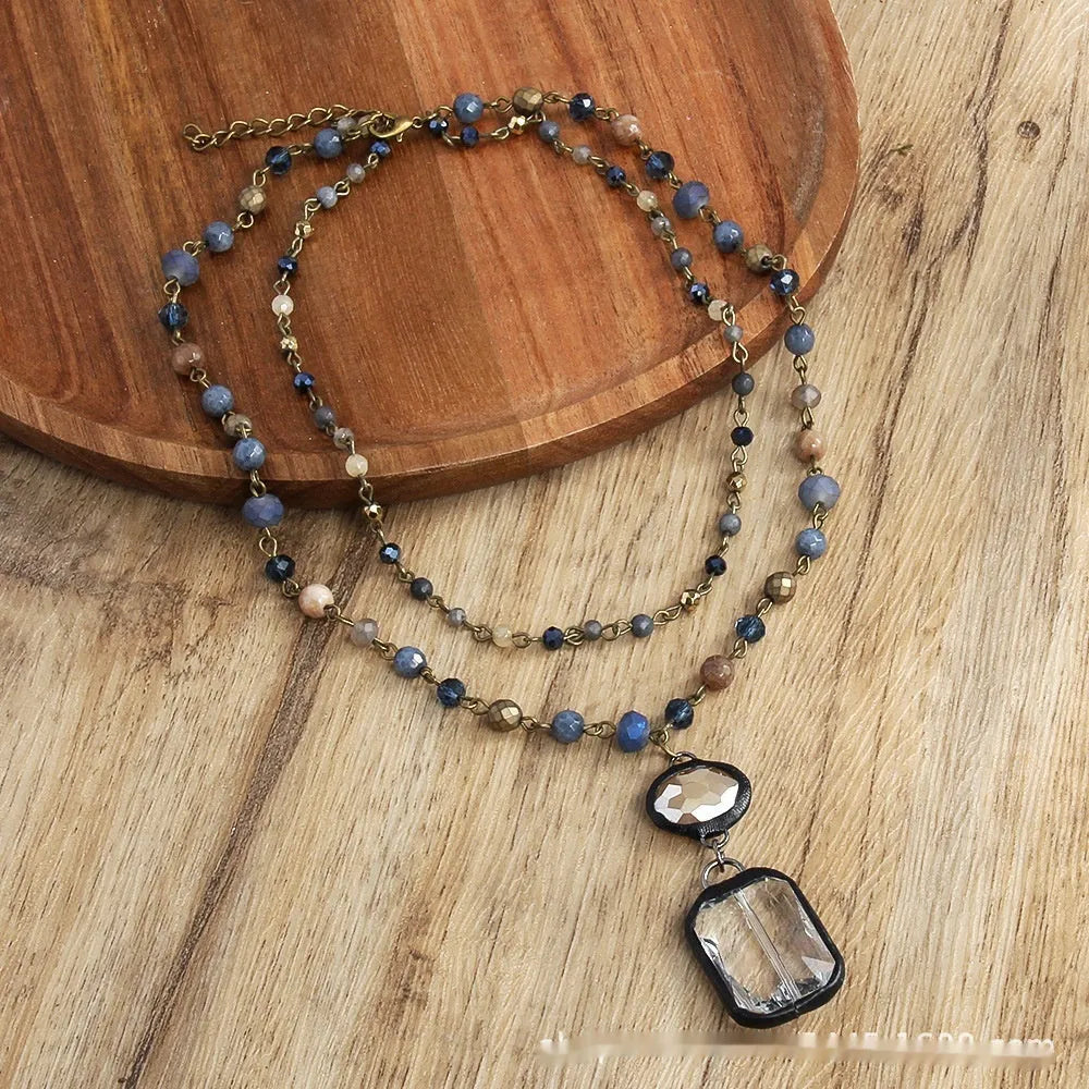 Two-layer tribal style necklace with glass and stone pendants on adjustable chain