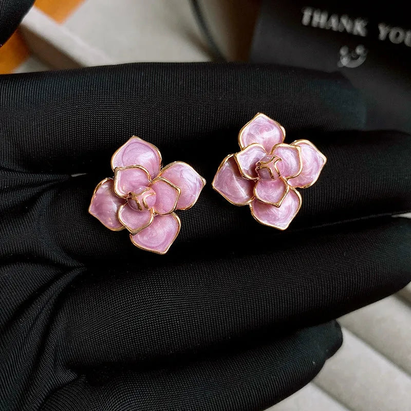 Gold plated purple oil-spot glaze flower stud earrings made from copper on a silver needle post.