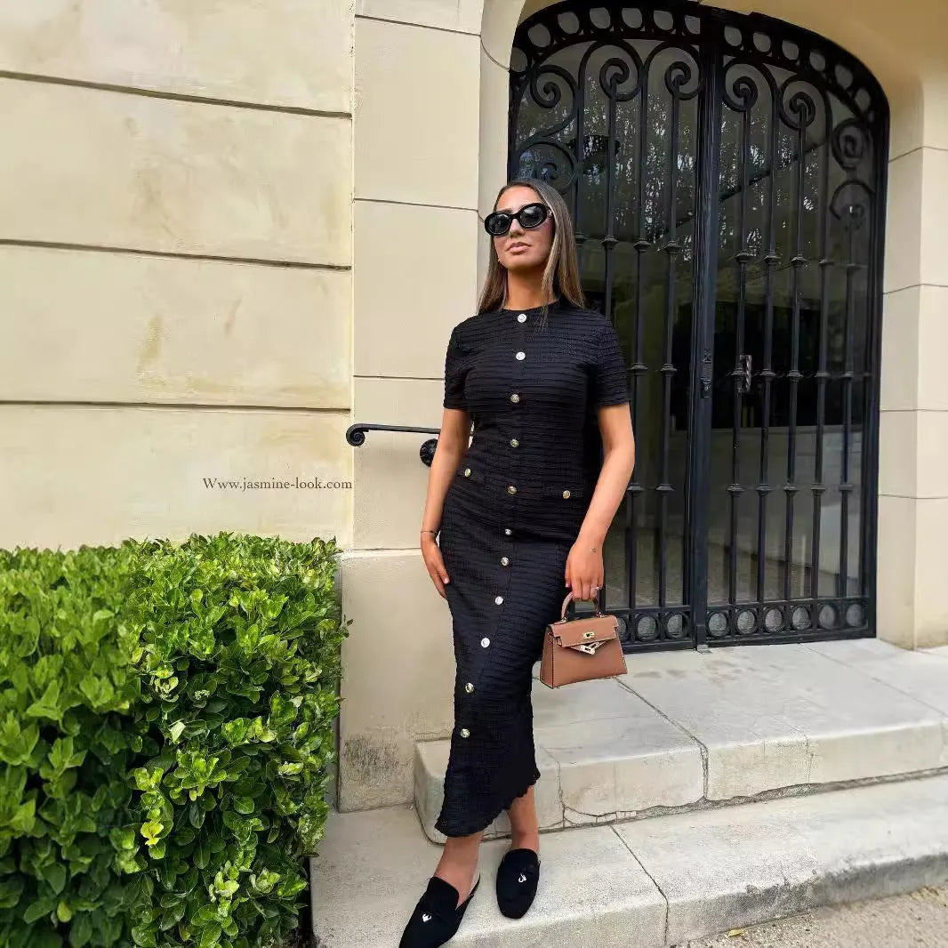 Black knitted long-sleeved slim fit dress with button detail on a mannequin.
