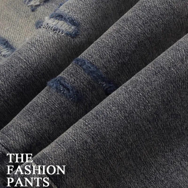 Old colour slim fit jeans with washed-out finish and embroidered hole patches
