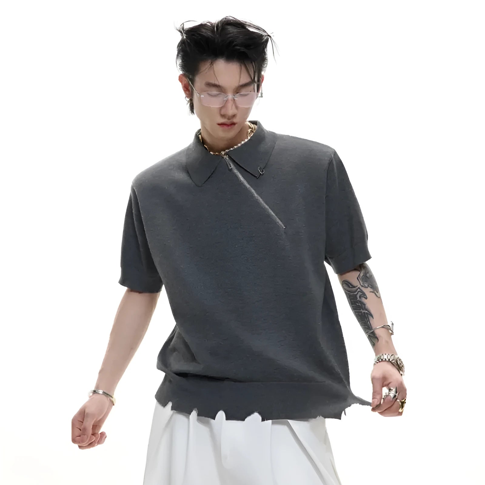 Man modelling a slim-fit black knitted polo shirt with an oblique diagonal zip closure and short sleeves.