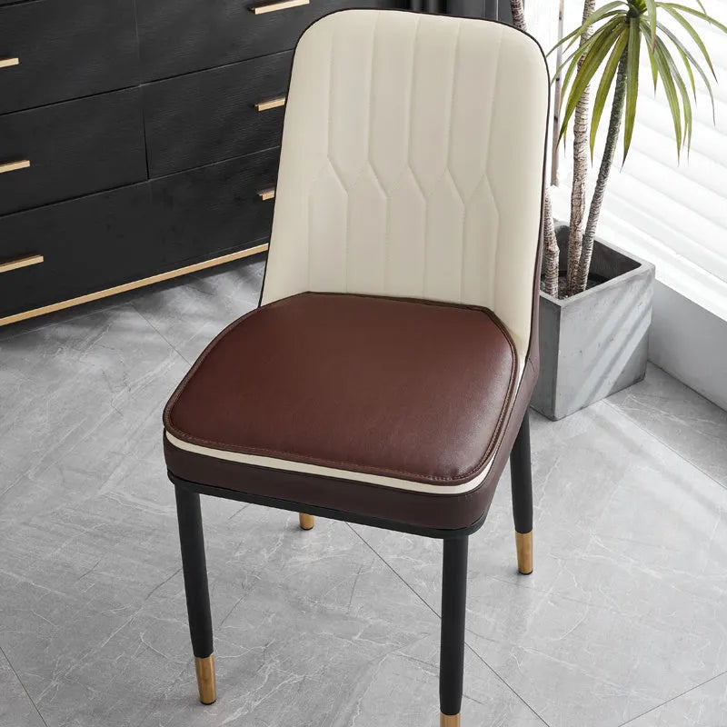Solid-colour leather horseshoe-shaped seat cushion showing non-slip base.