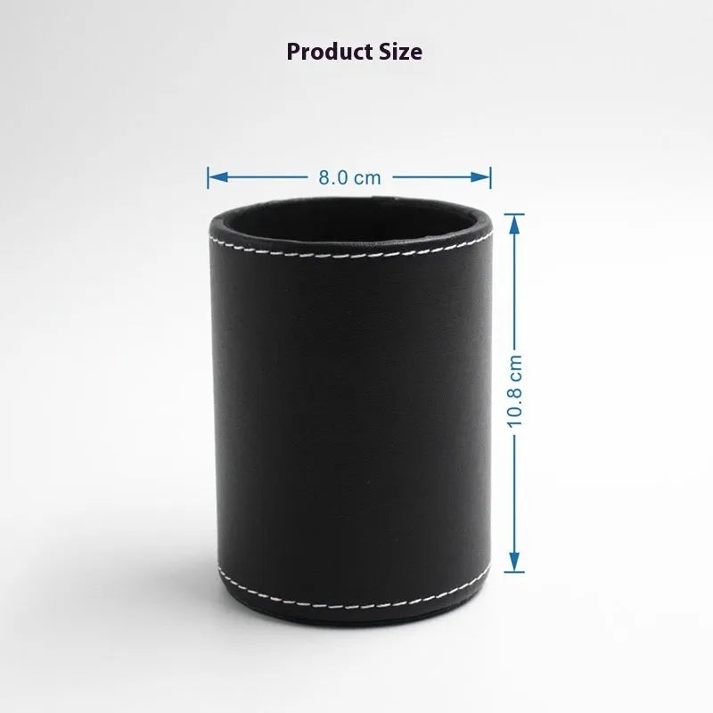 Round black leather pen holder on desk with pens