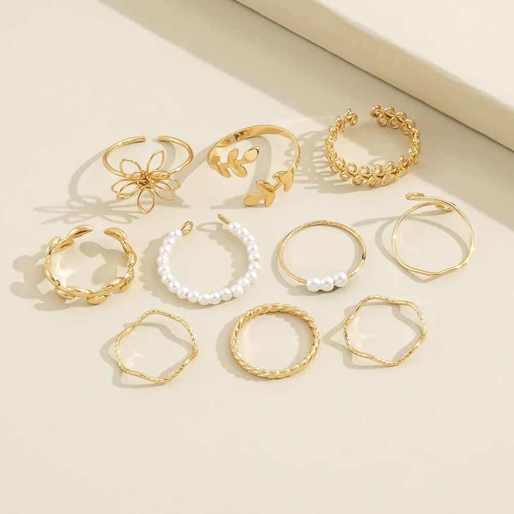 Women's gold alloy ring with openwork flower design and glossy electroplated finish