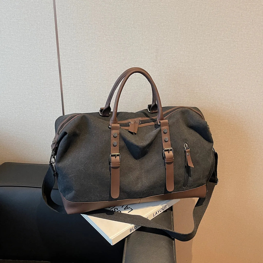 Canvas travel shoulder bag for men and women in solid black colour, breathable fabric, compact unisex design