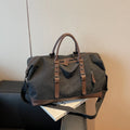 Canvas travel shoulder bag for men and women in solid black colour, breathable fabric, compact unisex design