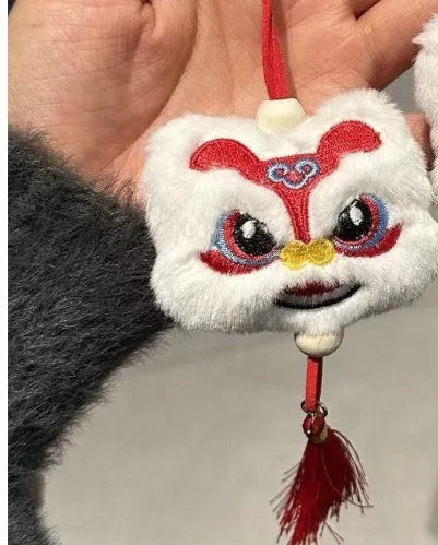 Blue and yellow Chinese style cartoon plush lion keychain ornaments with tassels and a star stone.