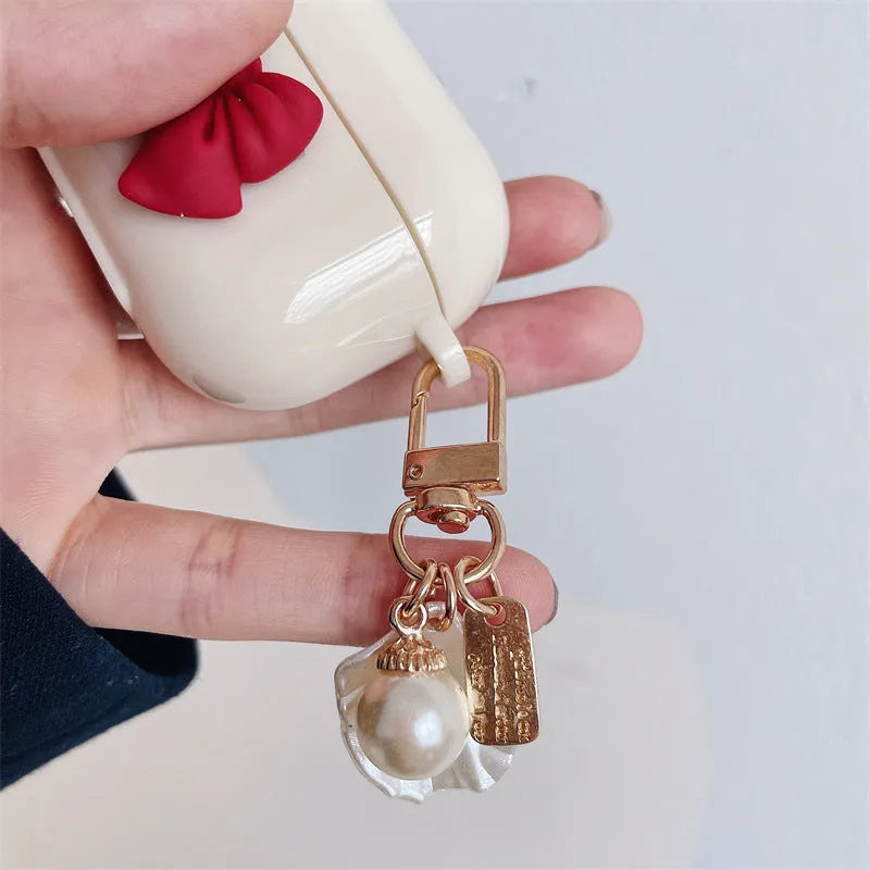 Beige red bow shell patterned TPU protective case for Apple AirPods Pro and AirPods 1, 2, 3 wireless earphones.