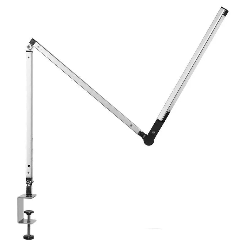 Aluminium LED desk lamp with a stainless steel clip mount and remote control on a wooden desk.