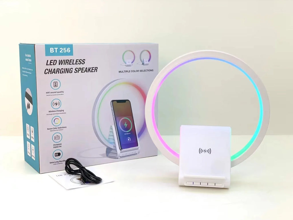 White smart Bluetooth speaker with integrated ambient light and 15W wireless charging pad on top.