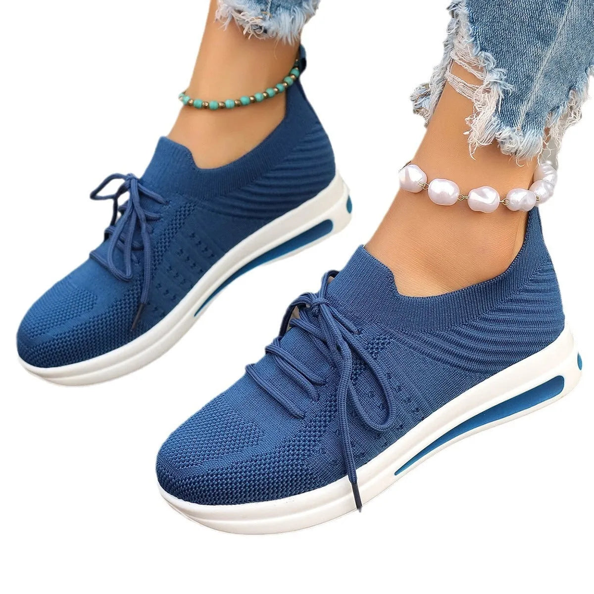 Women's red fly-knit low-top sneakers with round toe and front lace-up closure on artificial PU upper