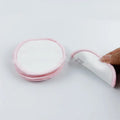 Set of four red and four blue velvet makeup remover pads next to a cotton mesh drawstring bag